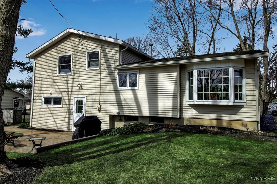 Backyard views: bricked paver patio, walkway + berm