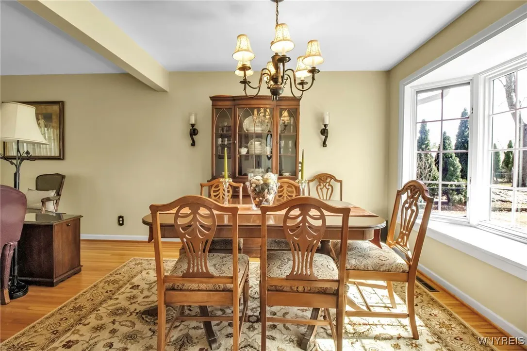 Formal DR w/HW flrs, pretty chandelier + bay window