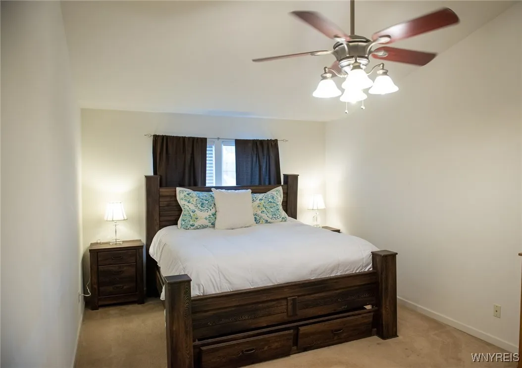Primary bedroom with a cathedral ceiling