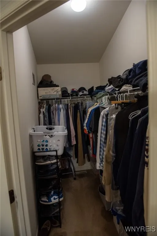 Walk in closet in the primary bedroom