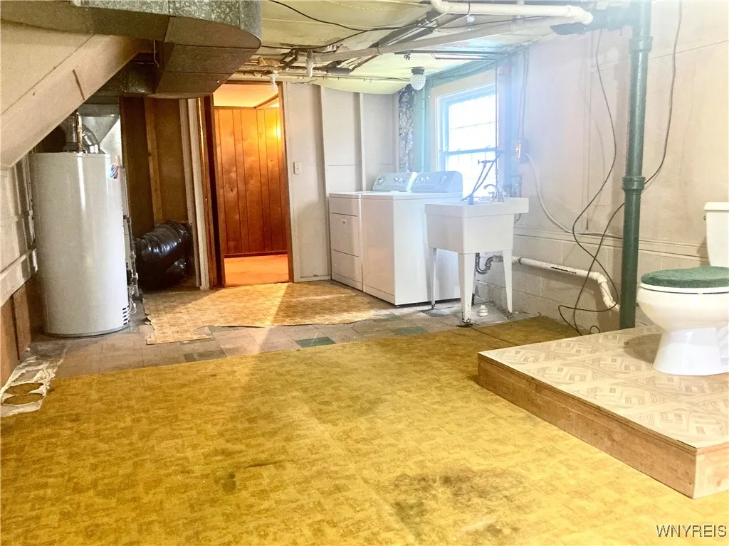 Daylight basement area/mechanicals, laundry & toilet