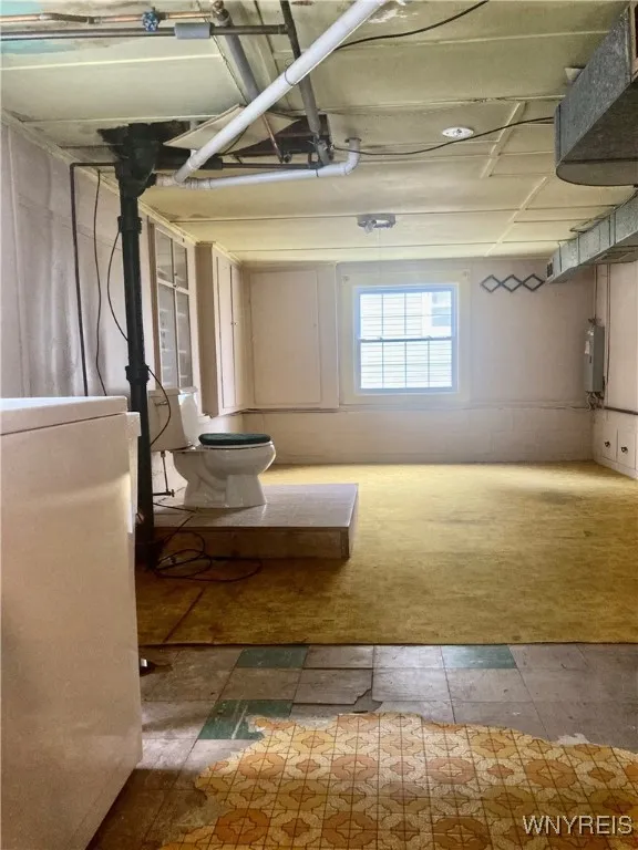 Daylight basement area/mechanicals, laundry & toilet