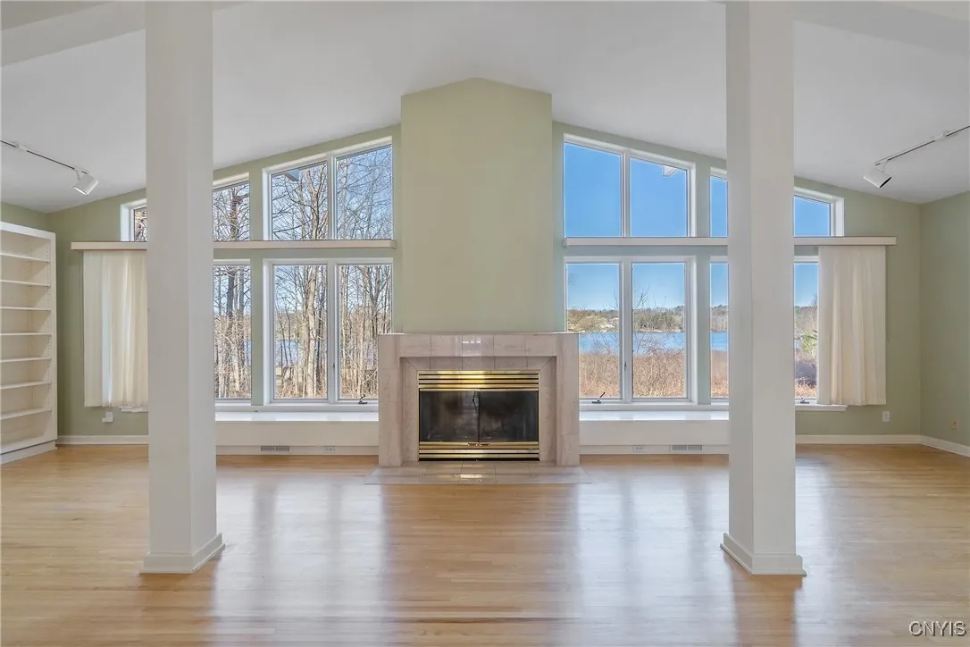 Living room with fireplace with Cazenovia Lake in the background