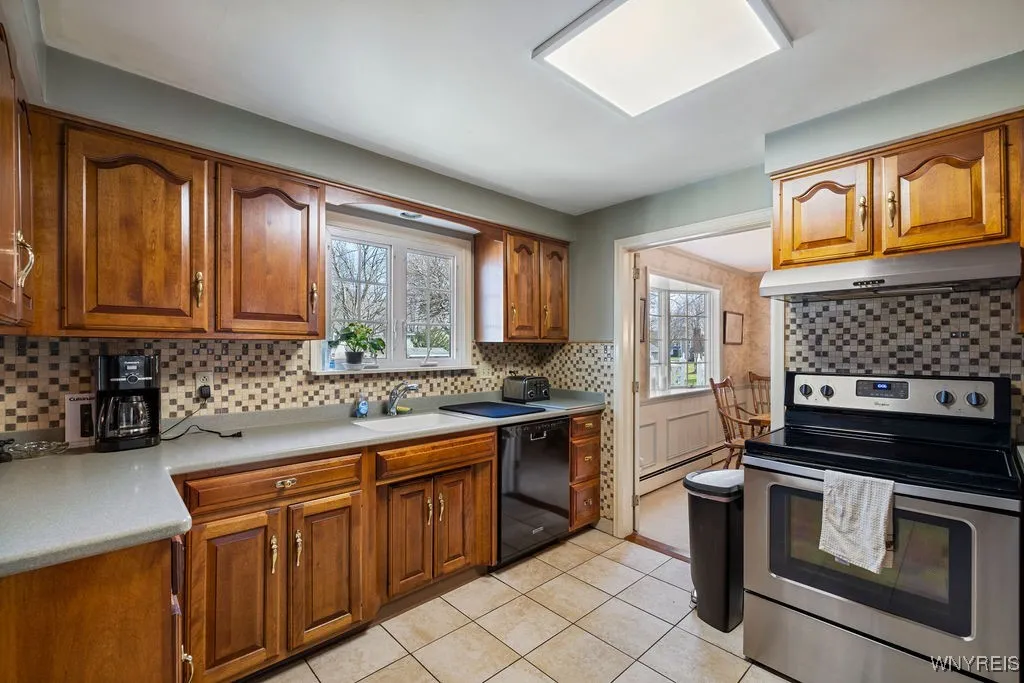 Newer kitchen with corian countertops and stainless steel appliances