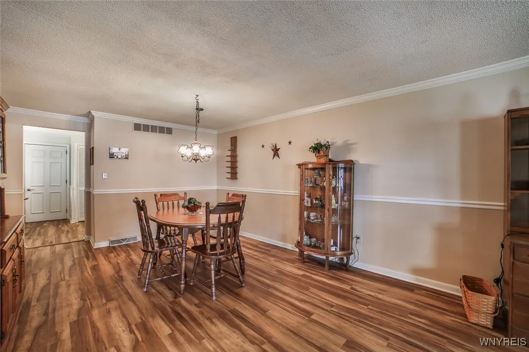 Great sized Formal Dining Room with Chair Rail and Cove Molding.