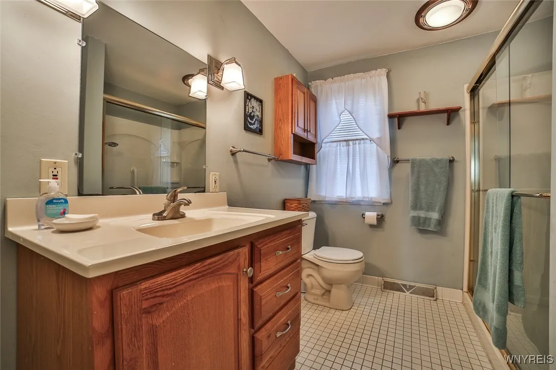 Uodated Main Bath with large step in shower and ceramic floor.