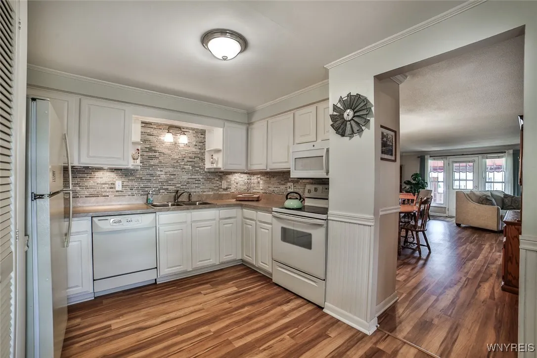 Wonderful white Kitchen with stunning backspash and all appliances stay!