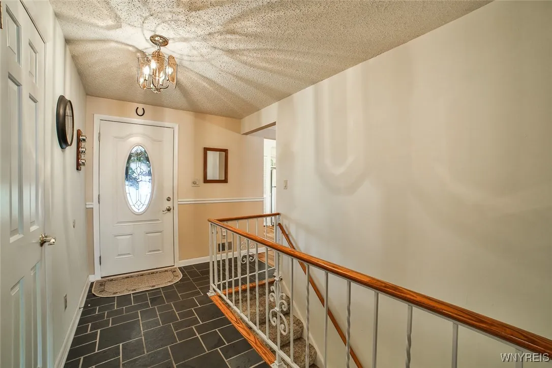 Charming entrance greets you with this slate foyer and coat closet.