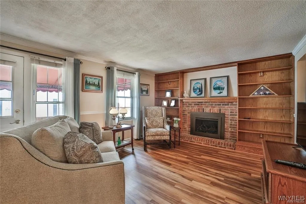 Spacious Living Room with gas fireplace, newer flooring and plenty of sunshine.