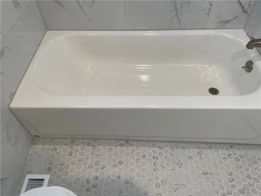 The new bathroom offers a brand new tub.