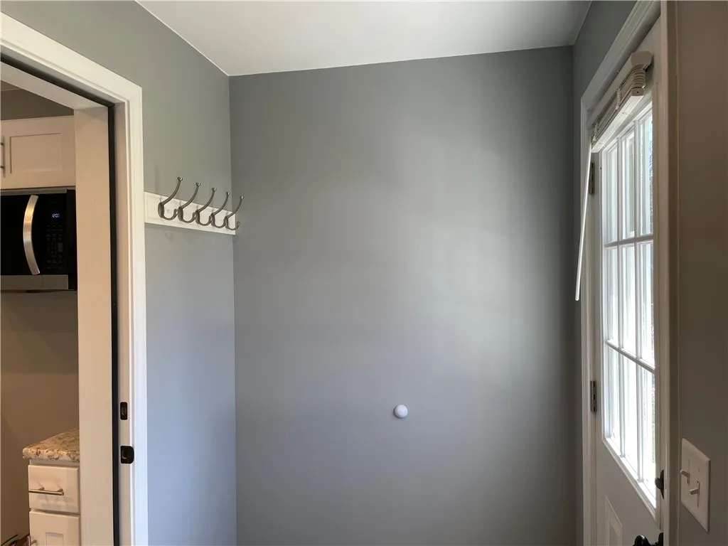 A view of the mudroom adjacent to the back door.