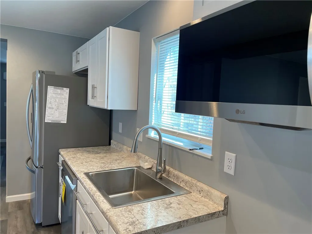 With the large windows, this kitchen is brightly lit.