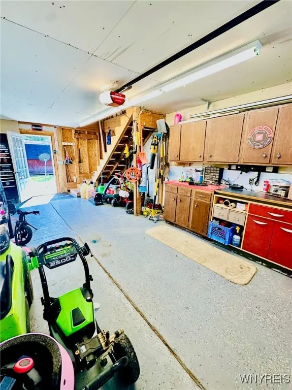 garage has additional cabinetry and full set of stairs to the 2nd floor. (It's possible for the golf cart to stay)