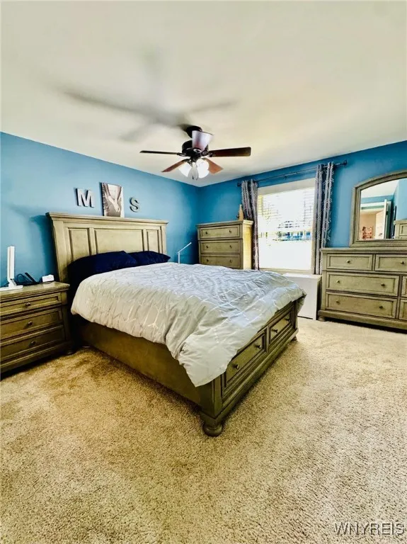 Master Bedroom with newer carpet and ceiling fan