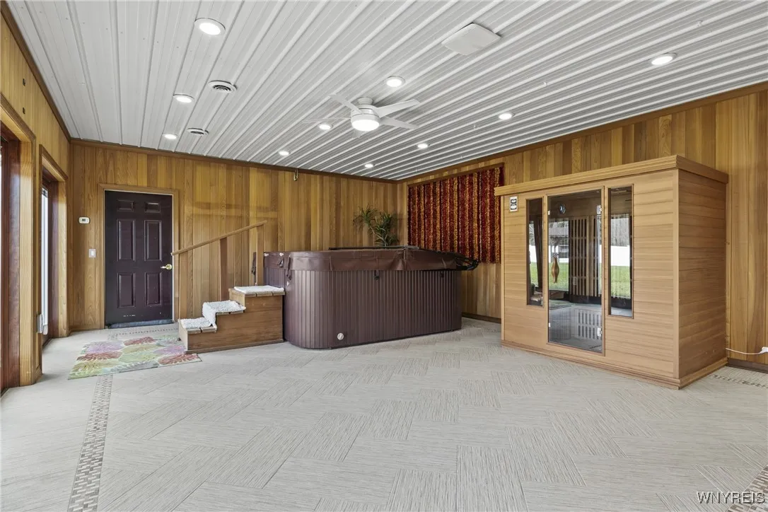Spa room with hot tub, sauna, radiant floor heating .  Doors to the outside patio