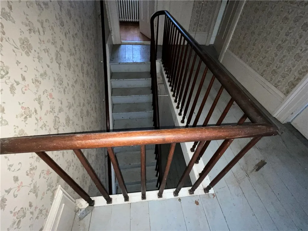 A wider view of the staircase from upstairs.