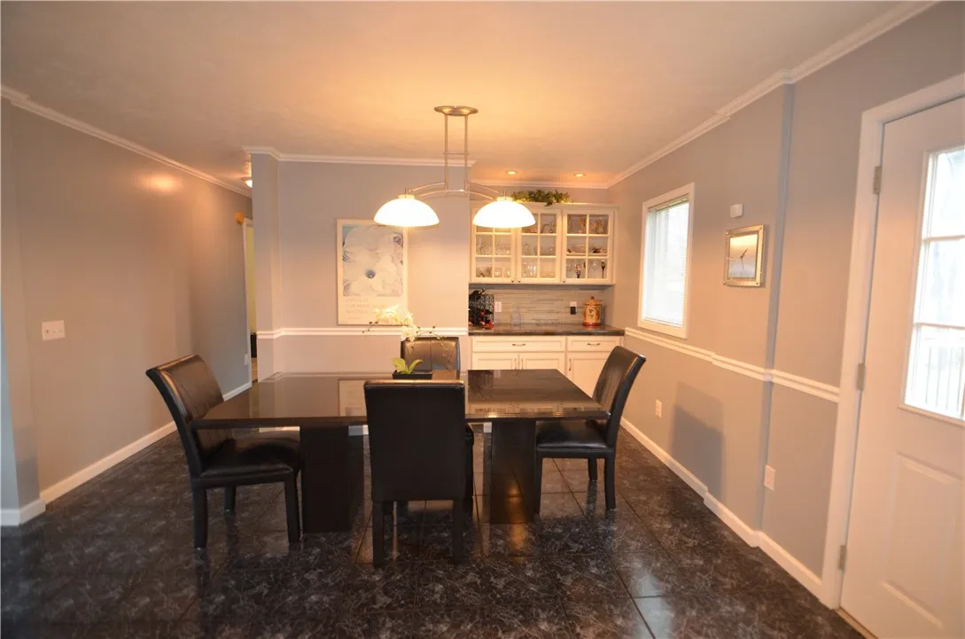 dining area with negoitable granite table and chairs