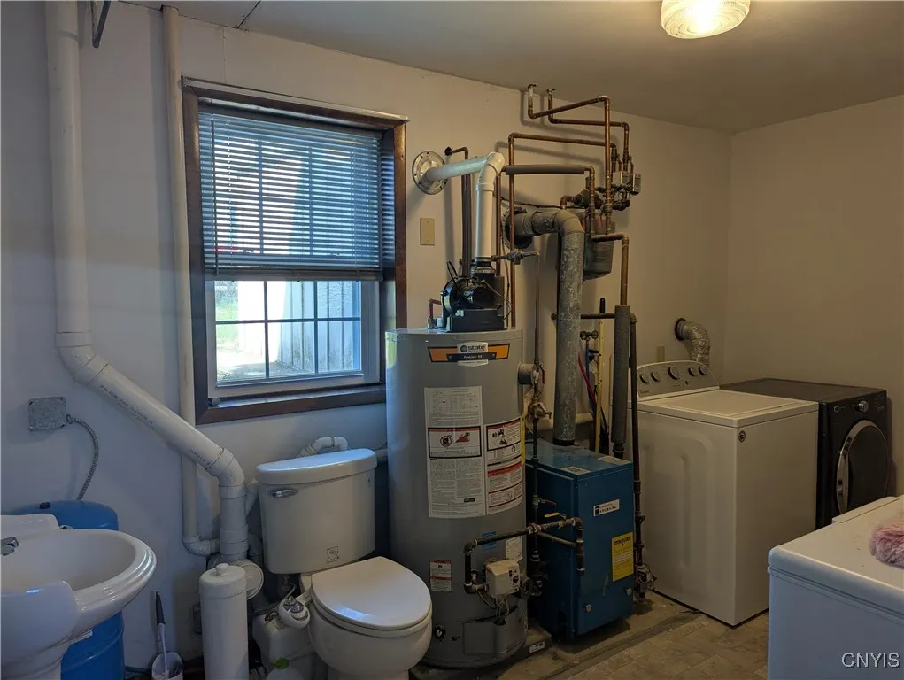 Utility room with half bath , gas-fired hot water heater   With power vent.