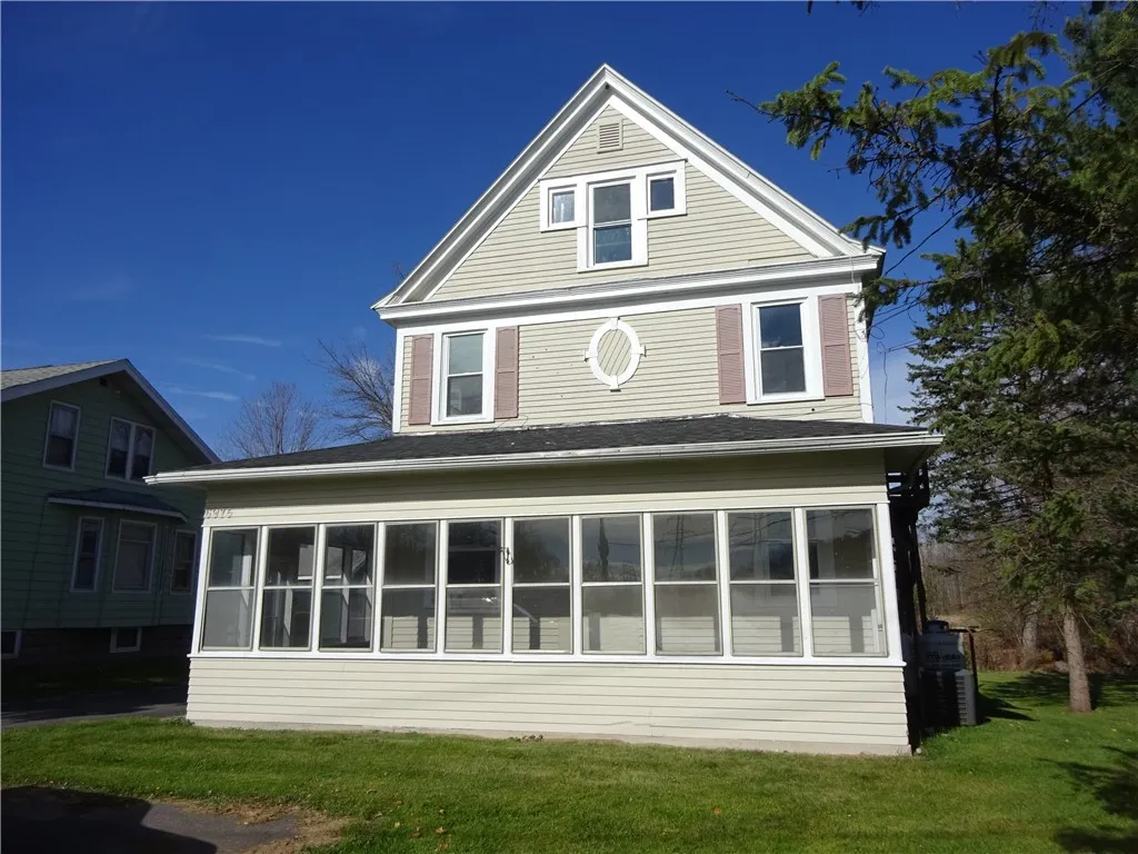 Large enclosed porch along the entire front.