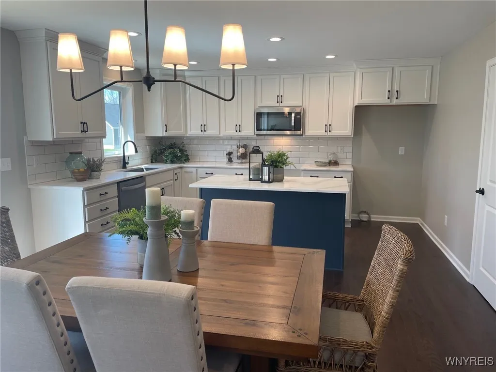 Beautiful white cabnitry with blue base cabinets on island, quartz countertops!