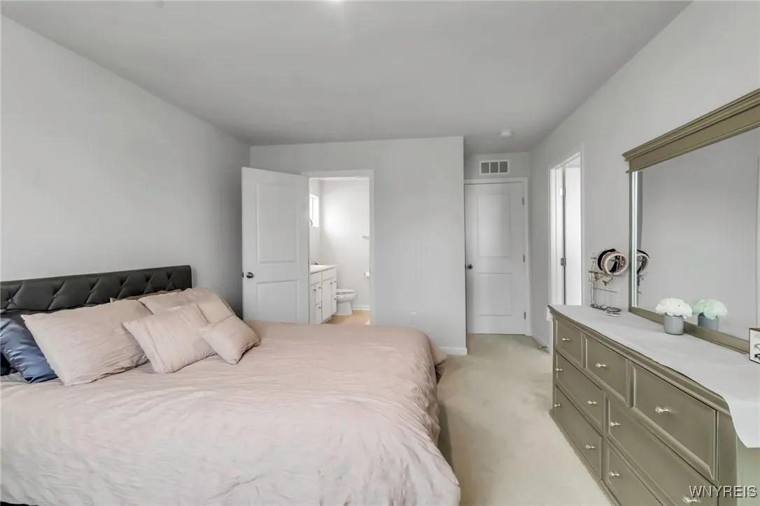 Primary bedroom - ensuite bath shown in the background
