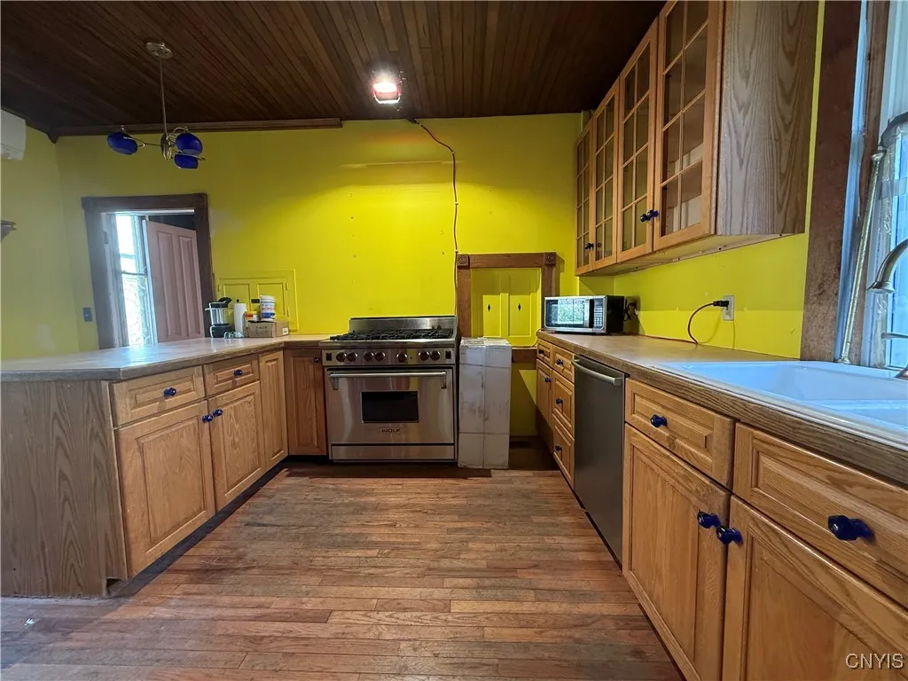 Brand new stove (Hood range sitting next to  stove and brand new sink located in a box in the back room off the kitchen