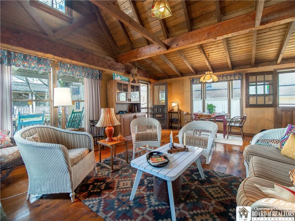 The sides and front of the home feature fixed and double hung windows, while the rear wall of the cottage features screened openings which are covered in the winter months.