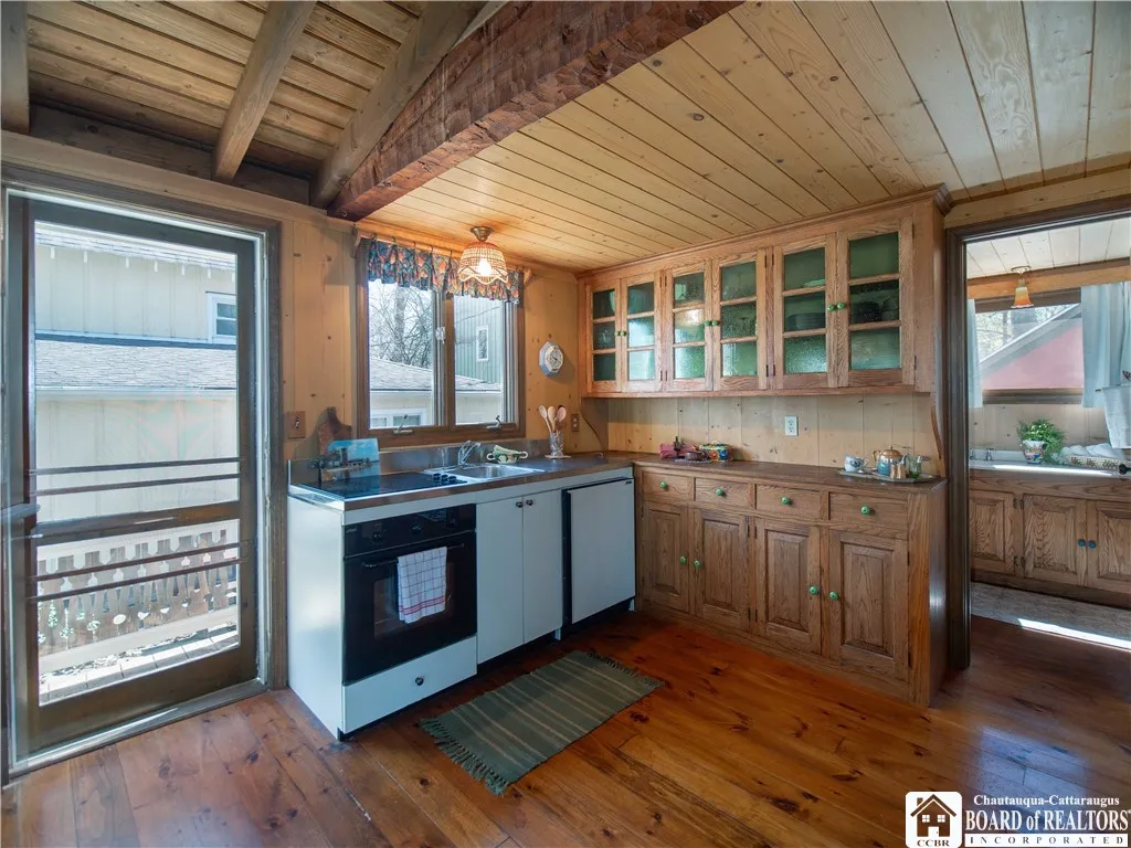 The galley kitchen is complete with a stove and an undercounter refrigerator.