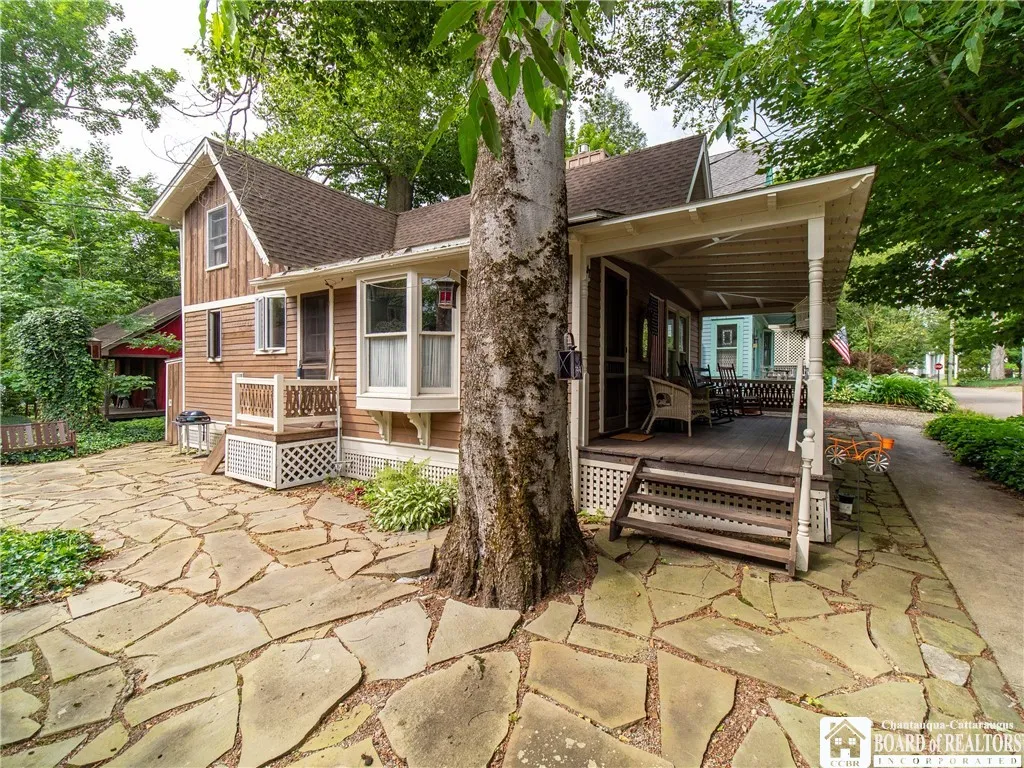 The paver courtyard leads to the front porch and the side entrance of the main​​‌​​​​‌​​‌‌​‌‌​​​‌‌​‌​‌​‌​​​‌​​ cottage.