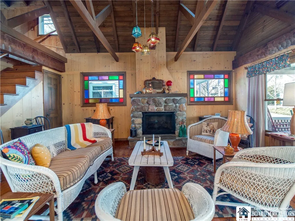Gather around the stone fireplace, flanked by beautiful matching stained glass windows.