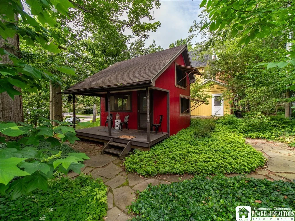 Nestled in the woods, the bunkhouse affords additional living space.