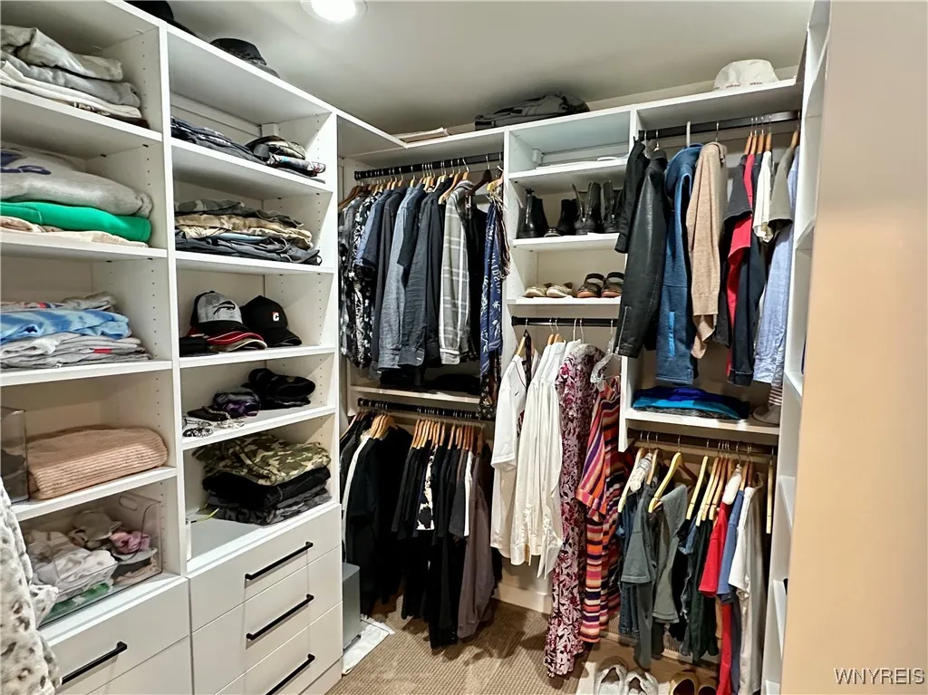 Custom walk-in closet has plenty of well thought out shelves