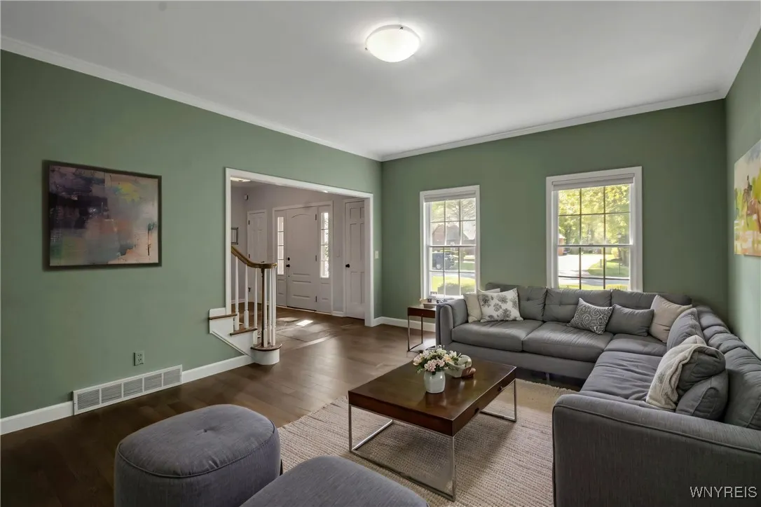 Living Room is vacant and photo is staged with furnishings for visual perspective only