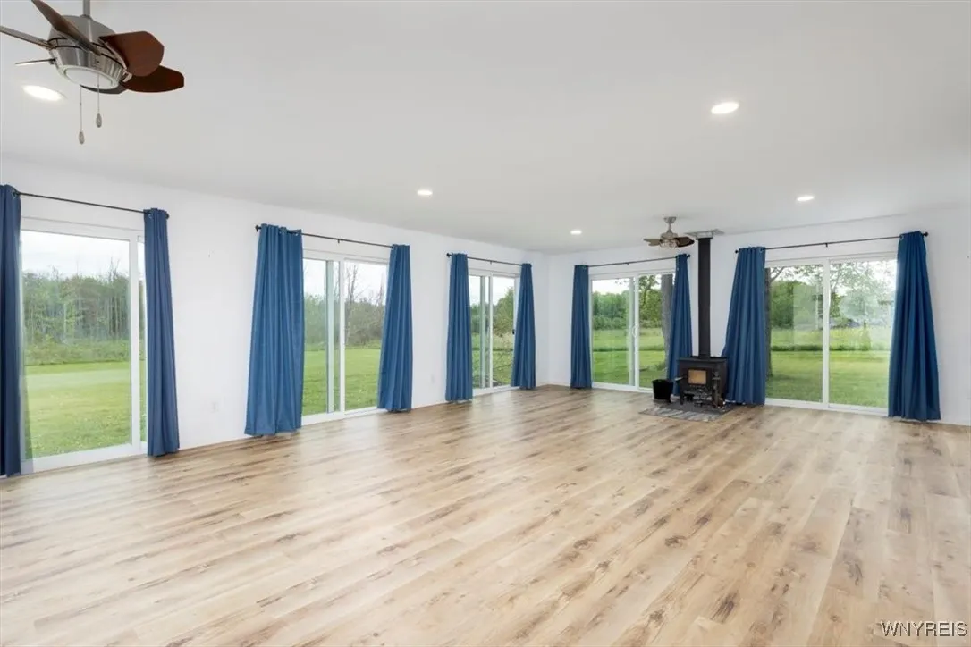expansive sitting/dining area with 6 sliding glass doors