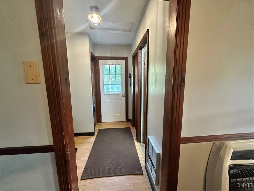 Hallway which has storage for shoes and coats and also access to full bathroom.