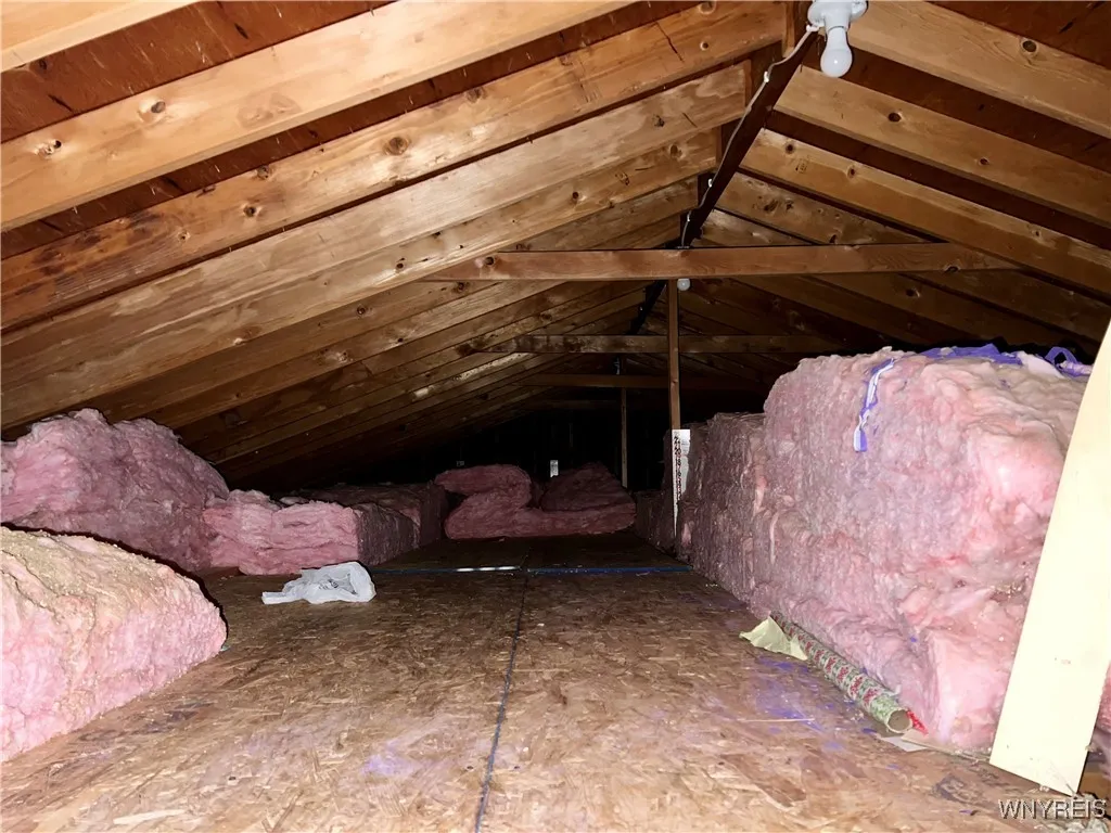 Dropdown stairs to attic.  Insulation stacked for storage space.