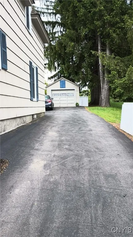 Driveway to 1 car garage with garage opener and 2 spots parallel to each other