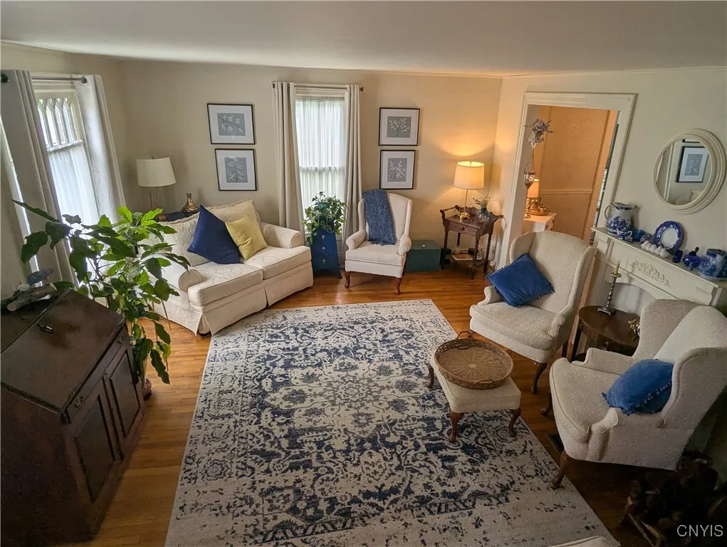 Grand size living room offers Comfortable space for  Family and friends. 2 sets of Drapes do not covey with sale All other widow coverings convey. All blinds convey.