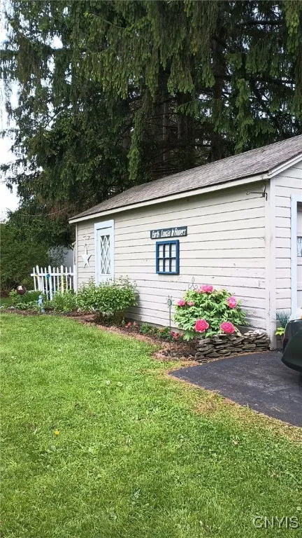 Side of garage ajoining  flower garden . Sign on garage does not convey with sale.\n