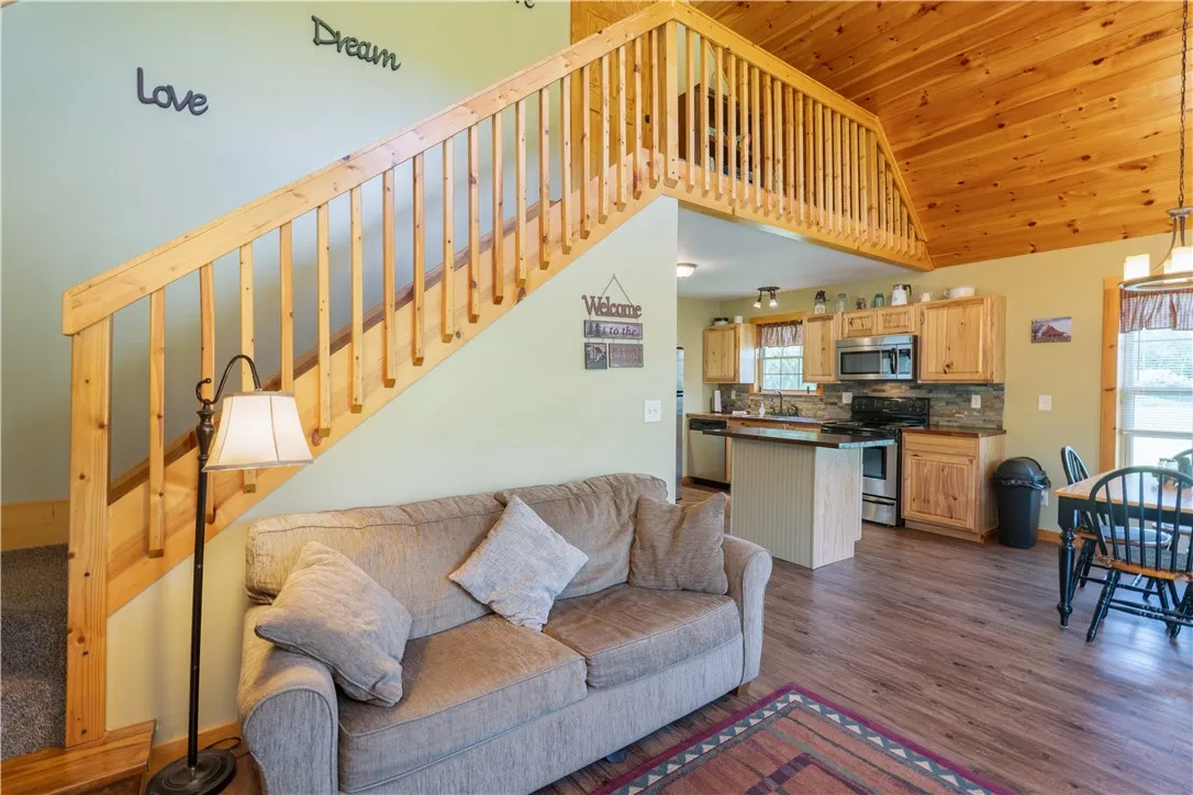 living room w/ stairs leading to the loft