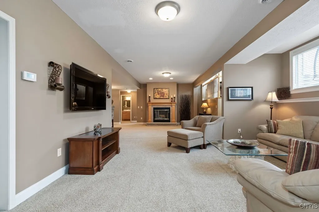 LOWER LEVEL FAMILY ROOM WITH HEATED FLOORS AND THIS FIREPLACE IS WOODBURNING SO THE HOLIDAY SMELLS ARE FUN! GREAT SPACE TO ENTERTAIN, WATCH THE BIG GAME AND ENJOY HOLIDAYS!