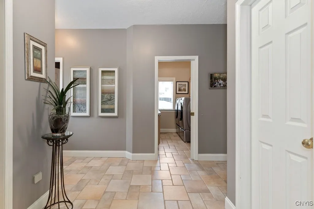1ST FLOOR BACK AND GARAGE ENTRANCE STEPS INTO A LARGE MUDROOM THAT ALSO CONNECTS TO A WONDERFUL LAUNDRY ROOM AND FULL BATH AS WELL. INCLUDED IN THE ROOM IS A HUGE COAT AND BOOT CLOSET AND A WALK-IN KITCHEN PANTRY!  THE TILE WORK IS FANTASTIC!