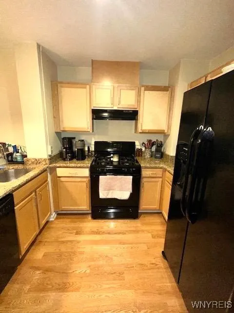 Fully applianced kitchen w/ granite counters.