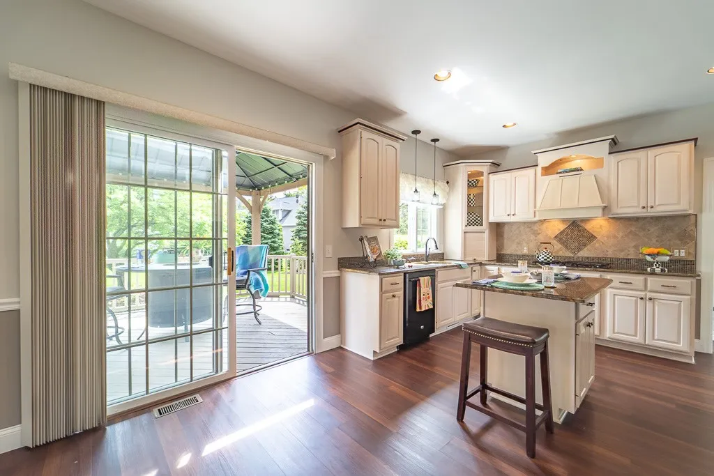 The eat-in area opens through sliding glass doors to a beautiful backyard.