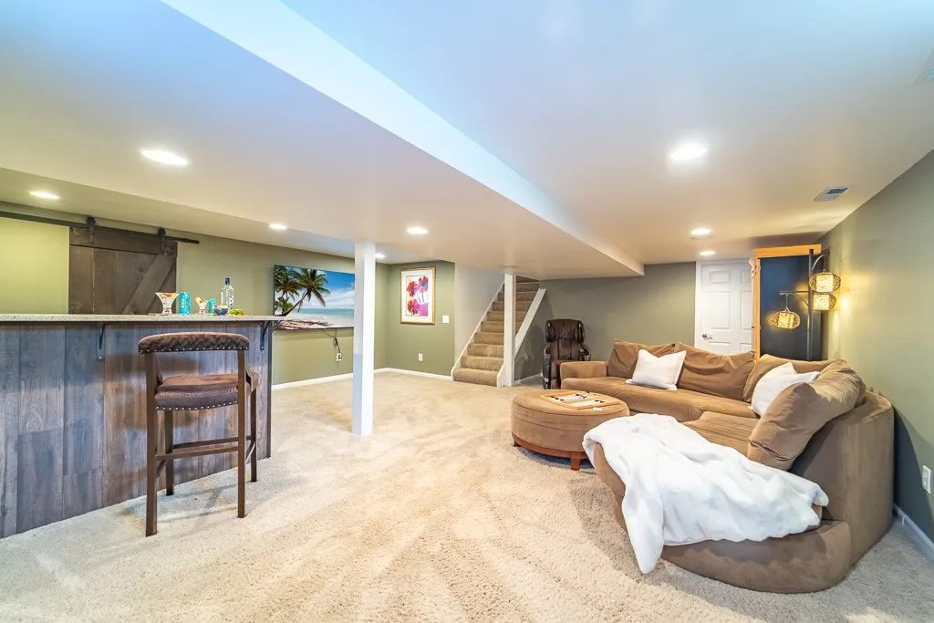 A striking sliding barn style door provides access to the mechanicals in the lower level.