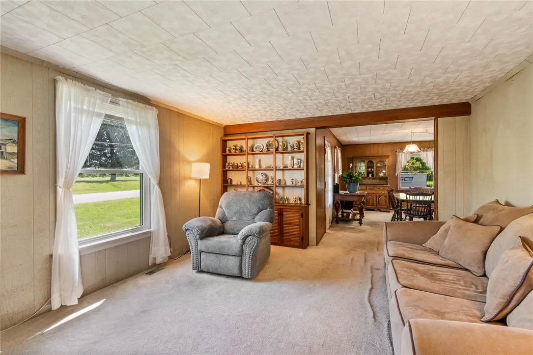 Living room to dining room- beautiful views of the country out of the updated windows