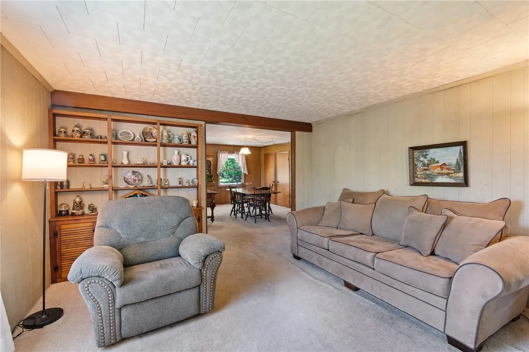 The living room- a comfortable place to relax- note the BUILT IN SHELVING- show off your prized possessions