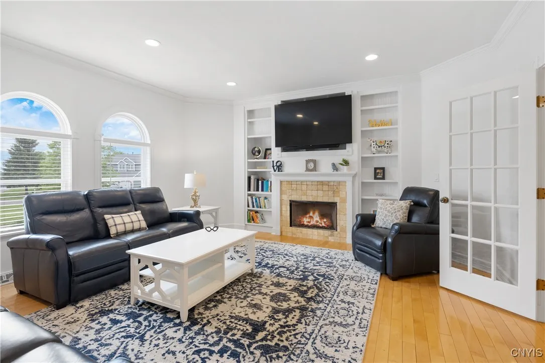 Gas fireplace on TV wall with built ins on either side. This room faces the front of the home.