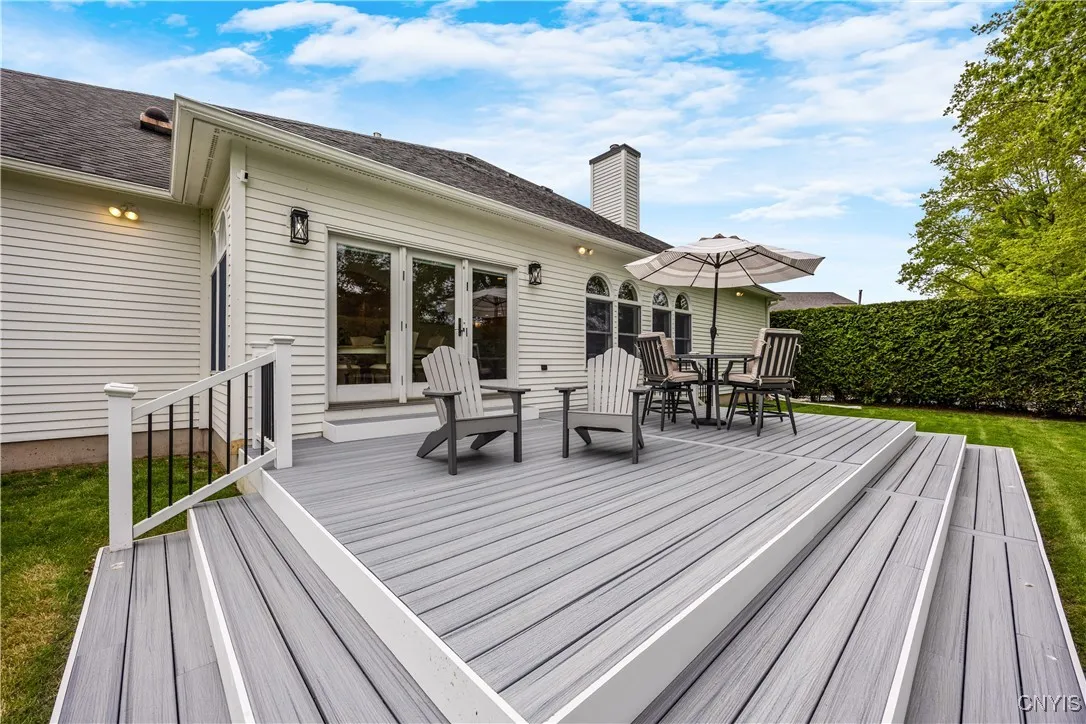 New Trex deck in backyard. Surrounded by tall hedgerow, the backyard is totally private.