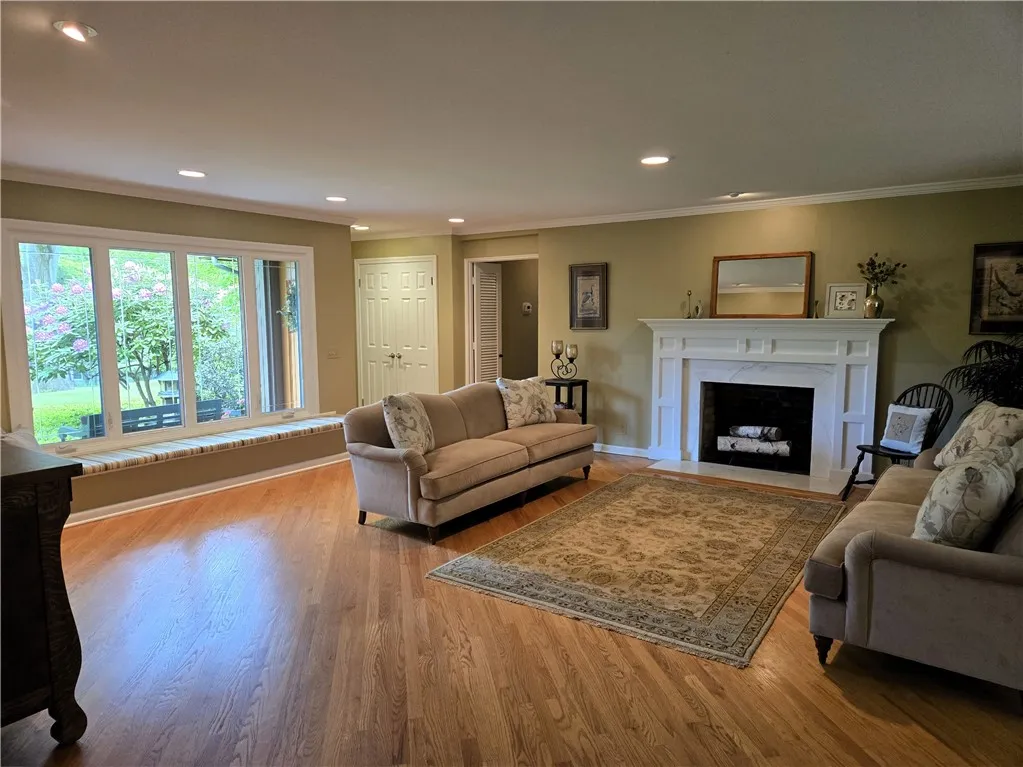 A closer look at the formal living room, second fireplace and long window seat.